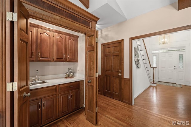 649 Westledge Ct, Des Peres, MO 63131 - bar area with wood finished floors, stairs, and a chandelier