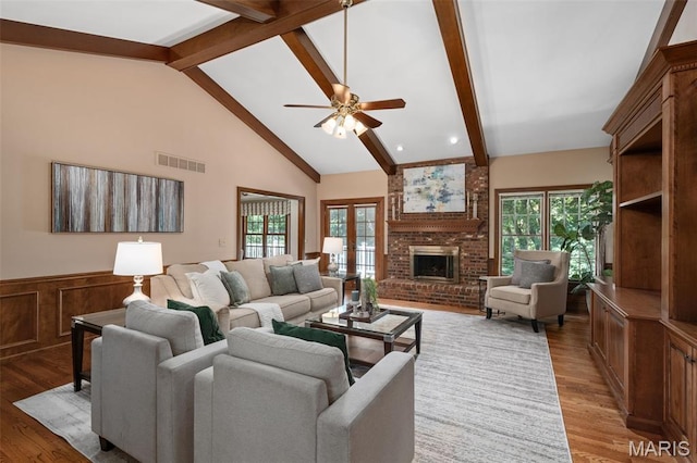 649 Westledge Ct, Des Peres, MO 63131 - living room featuring ceiling fan, healthy amount of natural light, wood finished floors, a fireplace, and wainscoting