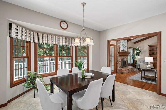 649 Westledge Ct, Des Peres, MO 63131 - dining area featuring a brick fireplace and a chandelier
