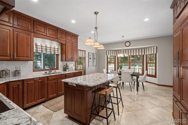 649 Westledge Ct, Des Peres, MO 63131 - kitchen featuring healthy amount of natural light, tasteful backsplash, recessed lighting, pendant lighting, and light stone countertops