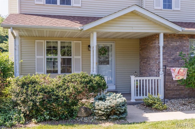 170 Coventry Way, Highland, IL 62249 - view of exterior entry featuring a porch and roof with shingles