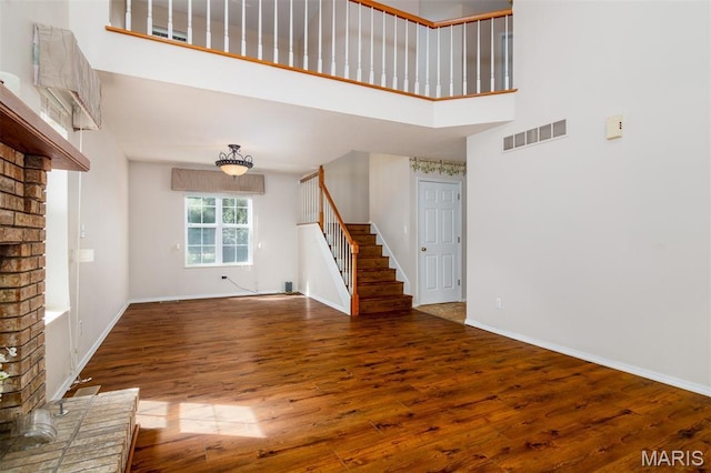 170 Coventry Way, Highland, IL 62249 - unfurnished living room with stairway, a towering ceiling, and wood finished floors