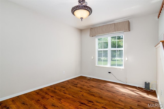 170 Coventry Way, Highland, IL 62249 - spare room featuring dark wood-style floors and baseboards