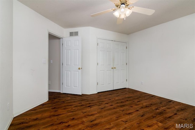 170 Coventry Way, Highland, IL 62249 - unfurnished bedroom with dark wood-type flooring, a closet, and ceiling fan