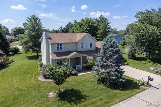 170 Coventry Way, Highland, IL 62249 - traditional-style house featuring a chimney, a front yard, and a porch