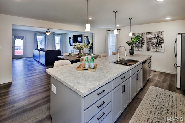 3092 Pirogue St, Saint Charles, MO 63301 - kitchen with appliances with stainless steel finishes, a center island with sink, dark wood-style flooring, a ceiling fan, and open floor plan