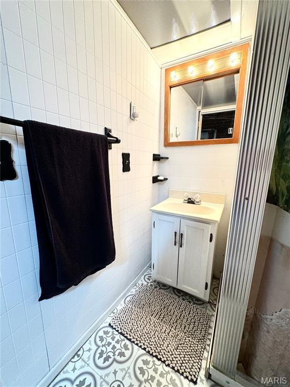56319 Meyer Trl, Hannibal, MO 63401 - bathroom featuring vanity, tile patterned floors, and tile walls