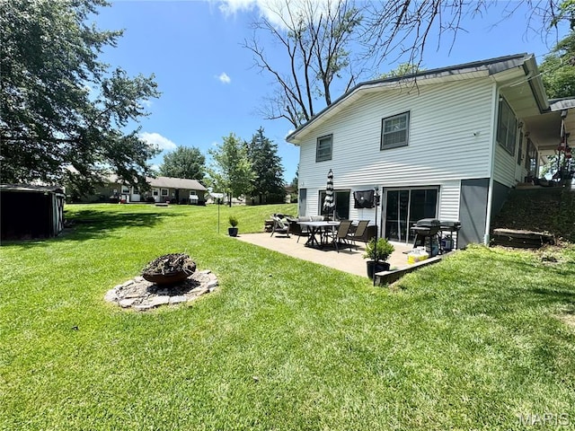 56319 Meyer Trl, Hannibal, MO 63401 - back of house featuring a fire pit, a yard, and a patio area