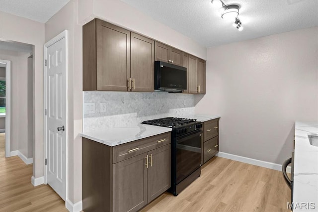 525 Homestead Ave, Swansea, IL 62226 - kitchen with black appliances, light wood-style floors, backsplash, a textured ceiling, and light countertops