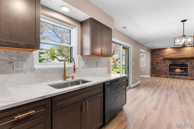 525 Homestead Ave, Swansea, IL 62226 - kitchen featuring stainless steel dishwasher, light wood-style floors, dark brown cabinetry, open floor plan, and light stone counters