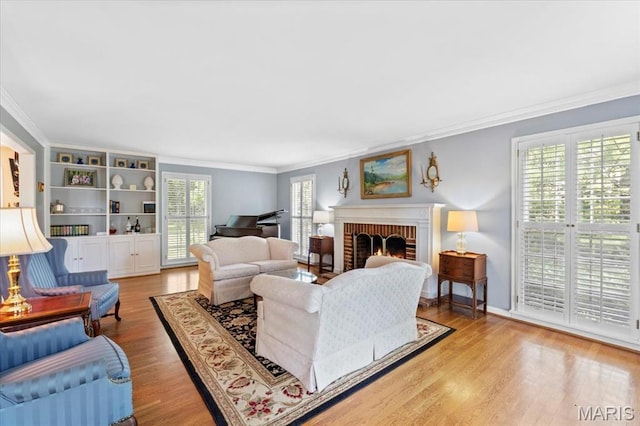 1843 Manor Hill Rd, Saint Louis, MO 63131 - living room with crown molding, a brick fireplace, and light wood-style flooring