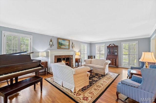 1843 Manor Hill Rd, Saint Louis, MO 63131 - living room with ornamental molding, a brick fireplace, and light wood-type flooring