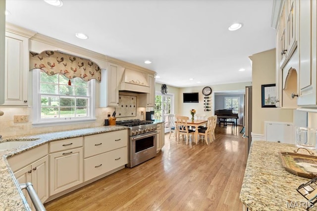 1843 Manor Hill Rd, Saint Louis, MO 63131 - kitchen with stainless steel range, premium range hood, plenty of natural light, tasteful backsplash, and recessed lighting