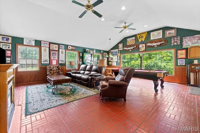 1843 Manor Hill Rd, Saint Louis, MO 63131 - living room with healthy amount of natural light, pool table, vaulted ceiling, brick flooring, and wainscoting