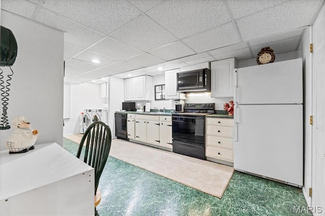 1843 Manor Hill Rd, Saint Louis, MO 63131 - kitchen with black appliances, washer and clothes dryer, a drop ceiling, recessed lighting, and light flooring