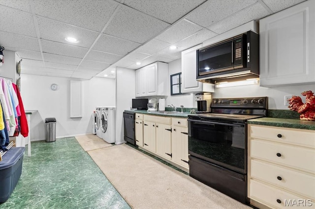 1843 Manor Hill Rd, Saint Louis, MO 63131 - kitchen with independent washer and dryer, black appliances, dark countertops, a drop ceiling, and recessed lighting