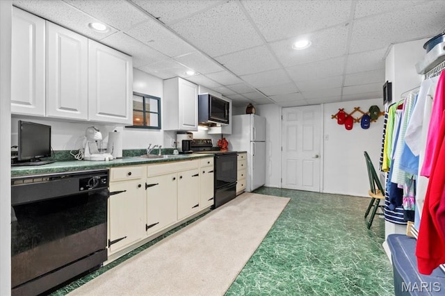 1843 Manor Hill Rd, Saint Louis, MO 63131 - kitchen with black appliances, dark countertops, white cabinetry, a drop ceiling, and recessed lighting