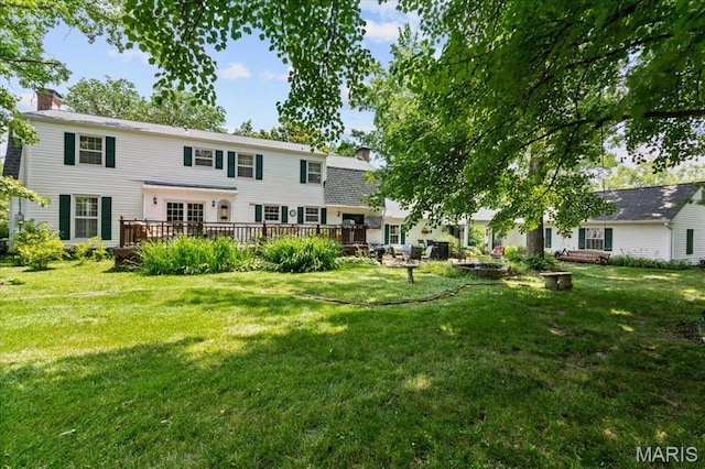 1843 Manor Hill Rd, Saint Louis, MO 63131 - rear view of house with a chimney, a deck, and a lawn