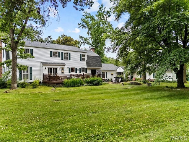 1843 Manor Hill Rd, Saint Louis, MO 63131 - back of house with a wooden deck, a chimney, a lawn, and roof with shingles