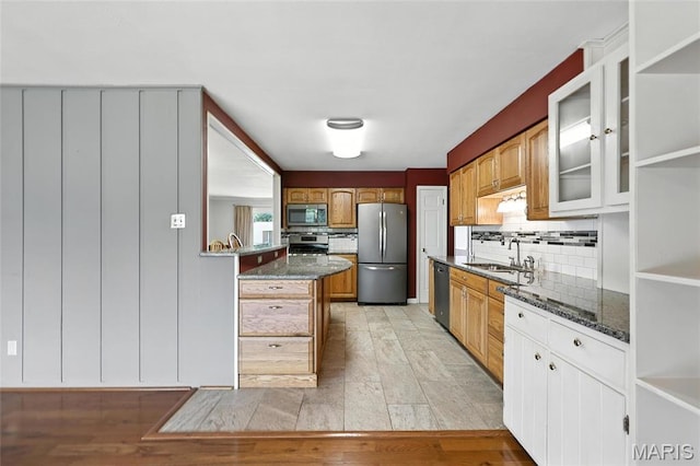 1467 Crystal Heights Rd, Crystal City, MO 63019 - kitchen featuring appliances with stainless steel finishes, backsplash, glass insert cabinets, dark stone counters, and light wood finished floors