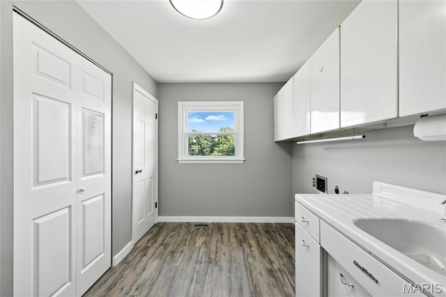 1467 Crystal Heights Rd, Crystal City, MO 63019 - washroom featuring cabinet space, washer hookup, dark wood-type flooring, and hookup for an electric dryer