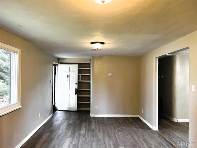 544 Hentschel Pl, Ferguson, MO 63135 - spare room featuring dark wood-style flooring and baseboards