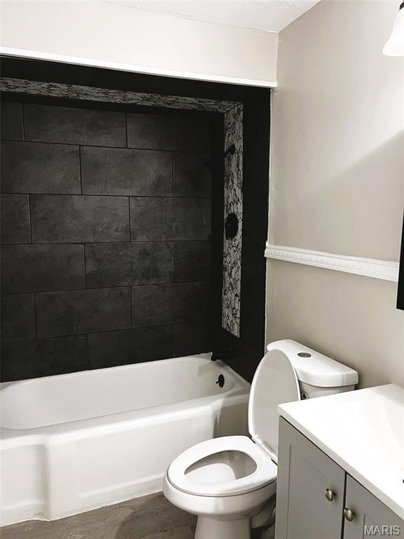544 Hentschel Pl, Ferguson, MO 63135 - bathroom featuring vanity, shower / tub combination, and wood finished floors