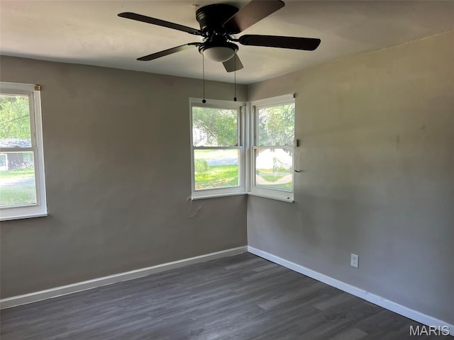 544 Hentschel Pl, Ferguson, MO 63135 - empty room with a ceiling fan, dark wood-type flooring, and healthy amount of natural light