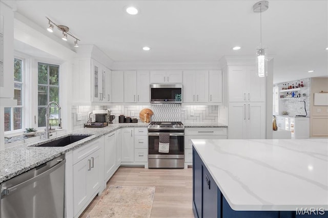 447 Maymont Dr, Ballwin, MO 63011 - kitchen with appliances with stainless steel finishes, white cabinetry, backsplash, pendant lighting, and recessed lighting