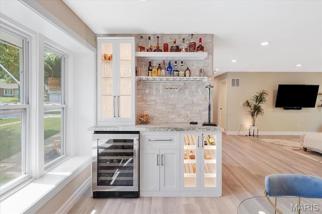 447 Maymont Dr, Ballwin, MO 63011 - indoor dry bar with beverage cooler, light wood-type flooring, and recessed lighting