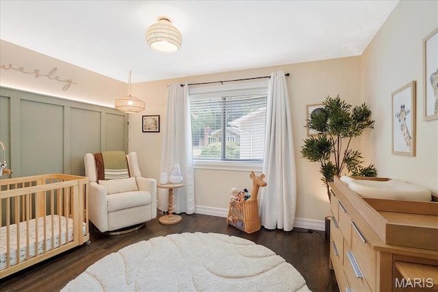 447 Maymont Dr, Ballwin, MO 63011 - bedroom featuring a nursery area and dark wood-style flooring