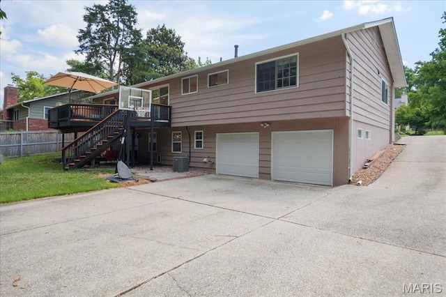 447 Maymont Dr, Ballwin, MO 63011 - view of front of property featuring a garage, a deck, driveway, and stairway