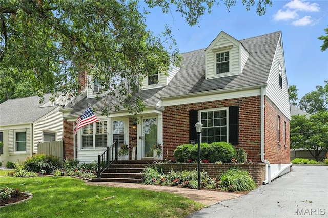 906 N Taylor Ave, Saint Louis, MO 63122 - cape cod house featuring brick siding, a front yard, and roof with shingles