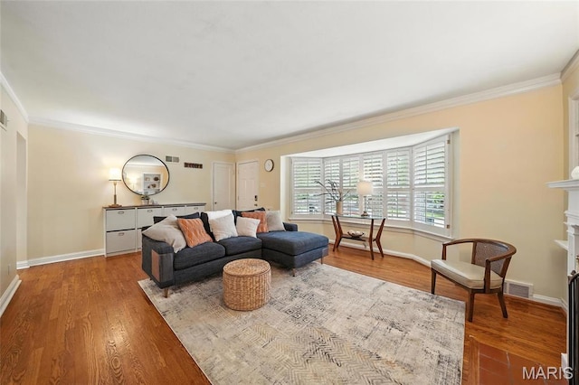 906 N Taylor Ave, Saint Louis, MO 63122 - living room with wood finished floors, crown molding, and a fireplace