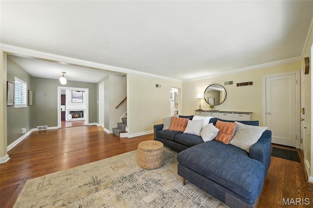 906 N Taylor Ave, Saint Louis, MO 63122 - living room with stairway, wood finished floors, a glass covered fireplace, and crown molding