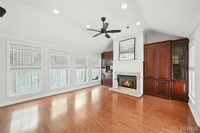 906 N Taylor Ave, Saint Louis, MO 63122 - unfurnished living room featuring lofted ceiling, a ceiling fan, a high end fireplace, light wood-style floors, and crown molding