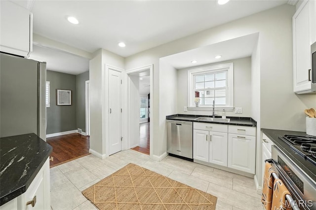 906 N Taylor Ave, Saint Louis, MO 63122 - kitchen with stainless steel appliances, recessed lighting, white cabinets, and light tile patterned floors