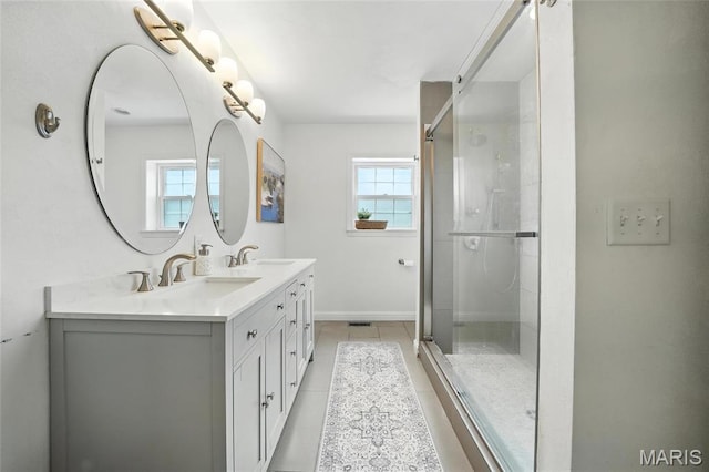 906 N Taylor Ave, Saint Louis, MO 63122 - bathroom with double vanity, a stall shower, and tile patterned floors