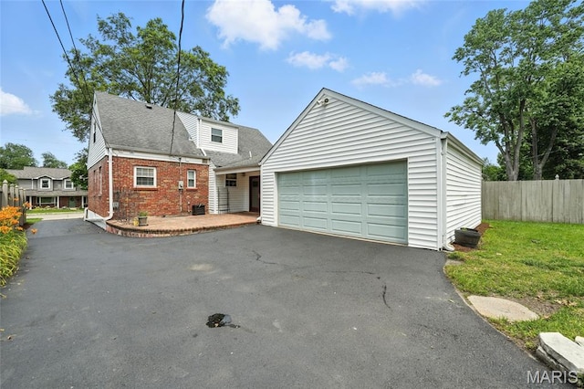 906 N Taylor Ave, Saint Louis, MO 63122 - view of front facade with brick siding, roof with shingles, and asphalt driveway