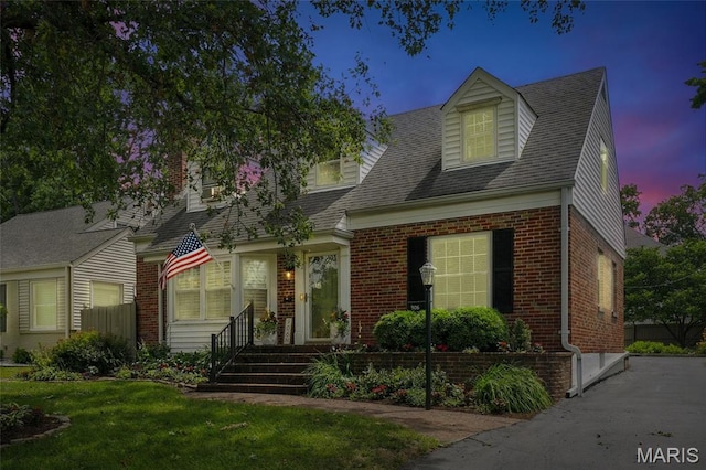 906 N Taylor Ave, Saint Louis, MO 63122 - cape cod home featuring brick siding, a front lawn, and a shingled roof