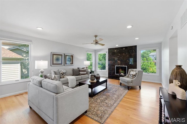 15747 Cedarmill Dr, Chesterfield, MO 63017 - living room with healthy amount of natural light, light wood finished floors, a fireplace, ceiling fan, and recessed lighting