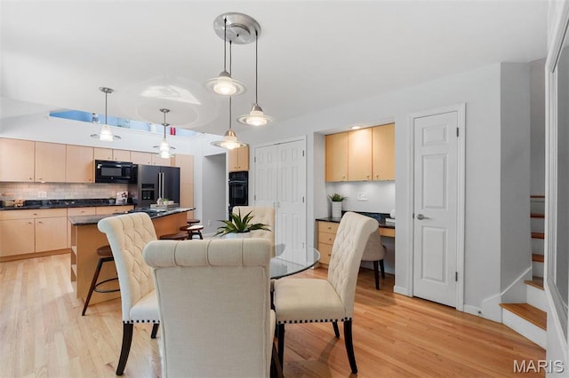 15747 Cedarmill Dr, Chesterfield, MO 63017 - dining space featuring light wood-type flooring and stairway
