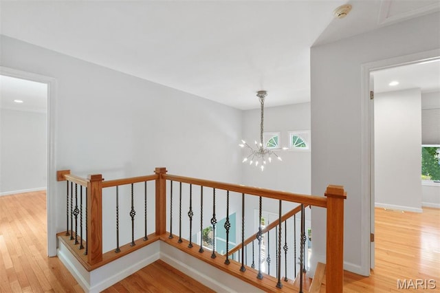 15747 Cedarmill Dr, Chesterfield, MO 63017 - corridor featuring a chandelier, light wood-style flooring, an upstairs landing, and recessed lighting