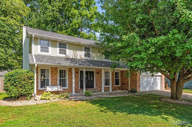 1026 Timber Creek Ln, Ofallon, IL 62269 - traditional home with a front yard, a porch, an attached garage, driveway, and brick siding
