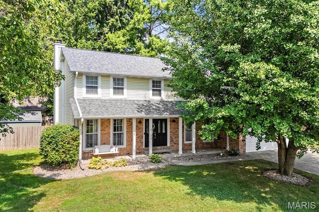 1026 Timber Creek Ln, Ofallon, IL 62269 - traditional-style home with a chimney, brick siding, a porch, concrete driveway, and roof with shingles