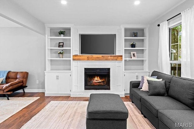 1026 Timber Creek Ln, Ofallon, IL 62269 - living area with wood finished floors, a brick fireplace, recessed lighting, and built in features