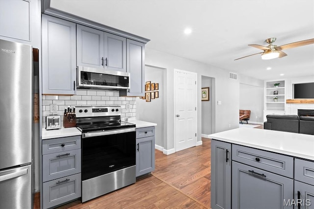 1026 Timber Creek Ln, Ofallon, IL 62269 - kitchen featuring stainless steel appliances, gray cabinets, ceiling fan, light countertops, and recessed lighting