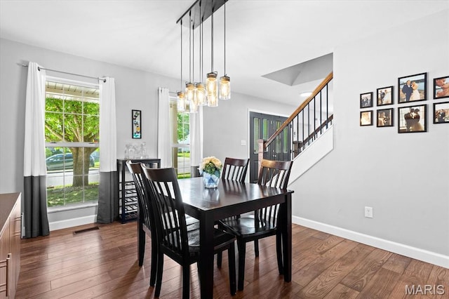 1026 Timber Creek Ln, Ofallon, IL 62269 - dining room with healthy amount of natural light, a chandelier, and dark wood-style flooring
