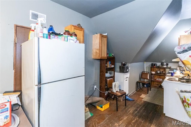 3815 N 20th St, Saint Louis, MO 63107 - kitchen with freestanding refrigerator, dark wood-style floors, and lofted ceiling
