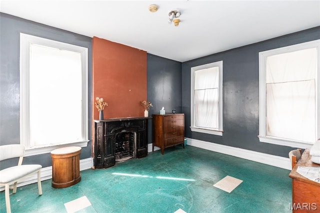 3815 N 20th St, Saint Louis, MO 63107 - unfurnished living room with plenty of natural light, a fireplace, and tile patterned floors